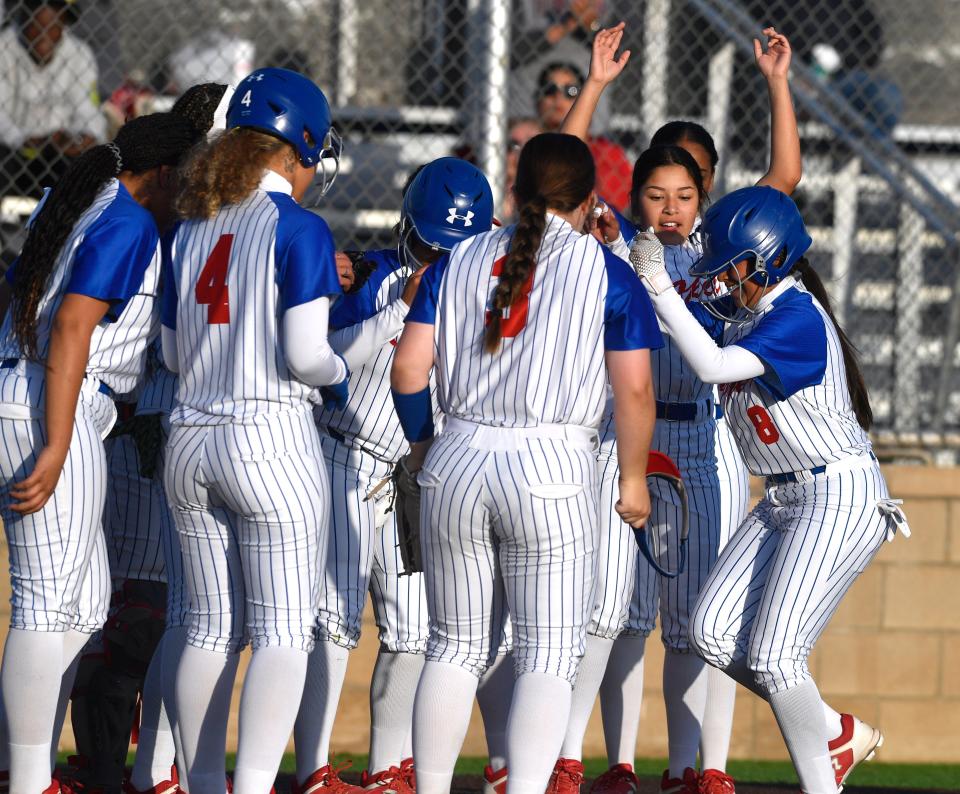 Cooper's Emma Ruiz is welcomed at home plate after hitting a home run against Lubbock Coronado.