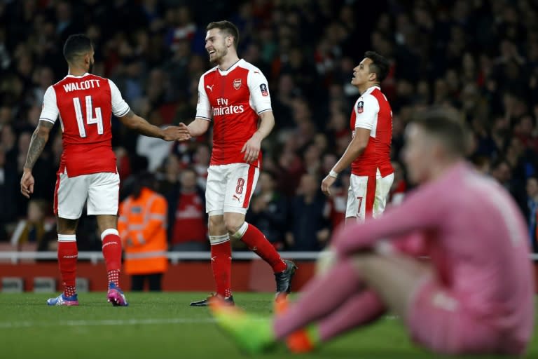 Arsenal's Aaron Ramsey (2nd L) celebrates with teammate Theo Walcott (L) after scoring their fifth goal against Lincoln City at The Emirates Stadium in London on March 11, 2017