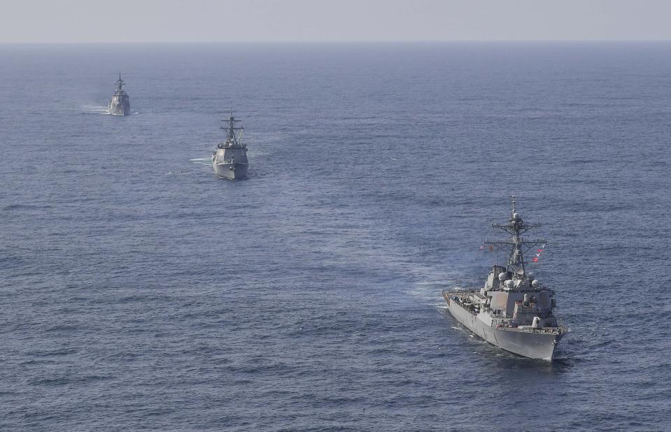 In this photo provided by South Korea Defense Ministry, U.S. Navy's the guided missile destroyer USS Benfold, right bottom, South Korean Navy's destroyer Yulgok Yi I and Japan Maritime Self-Defense Force's destroyer Atago, left top, sail during a joint missile defense drill among South Korea, the United States and Japan in the international waters of the east coast of Korean peninsular, Monday, April 17, 2023. The United States, South Korea and Japan will conduct a joint missile defense exercise Monday in waters near the Korean Peninsula as they expand military training to counter the growing threats of North Korea's nuclear-capable missiles, the South Korean navy said. (South Korea Defense Ministry via AP)