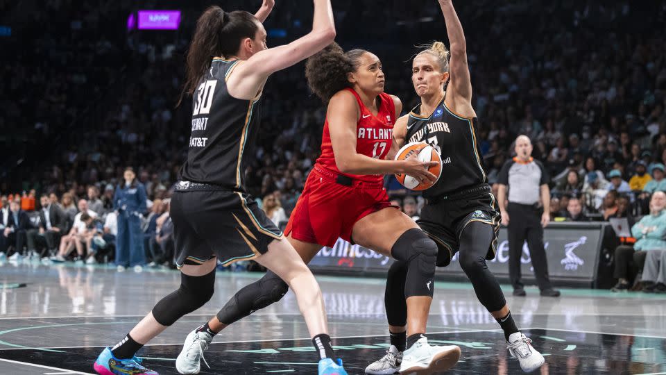 Atlanta Dream guard Haley Jones drives between New York Liberty forwards Breanna Stewart and Leonie Fiebich during the second half. - Corey Sipkin/AP