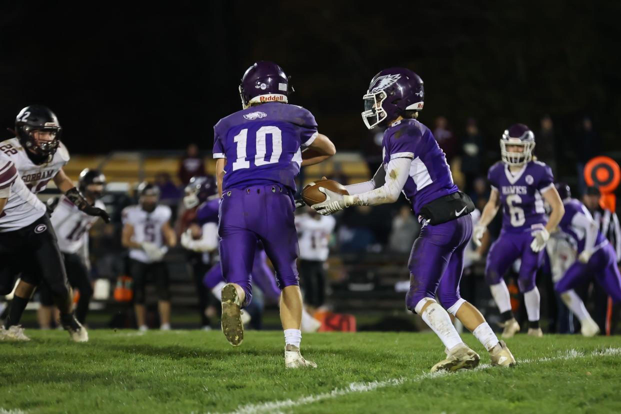 Marshwood quarterback Tyler Hussey fakes a handoff to Landon Waterman and runs up the middle during Tuesday's Class B South quarterfinal game in South Berwick, Maine.