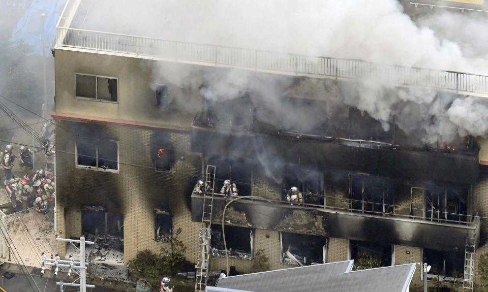 FILE - In this July 18, 2019, file photo, firefighters respond to a building fire of Kyoto Animation's No. 1 studio, in Kyoto, western Japan. Japanese police arrested on Wednesday, May 27, 2020, 42-year-old Shinji Aoba, the suspect in a deadly arson at the animation studio after the alleged attacker regained enough strength from his own injury to respond to police investigation. Aoba is accused of storming into the studio, setting it on fire and killing 36 people. (Kyodo News via AP)