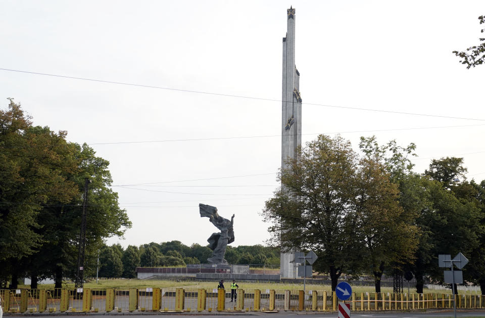 Barriers are placed around The Monument to the Liberators of Soviet Latvia and Riga from the German Fascist Invaders, in Riga's Victory Park, Latvia, Monday, Aug. 22, 2022. Authorities in Latvia say they will tear down a Soviet-era monument on Tuesday that commemorates the Red Army’s victory over Nazi Germany. (AP Photo/Roman Koksarov)