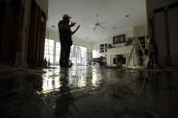 <p>Greg Ingram looks around his water-damaged home after floodwaters from Tropical Storm Harvey drenched the city Thursday, Aug. 31, 2017, in Houston. (Photo: Gregory Bull/AP) </p>