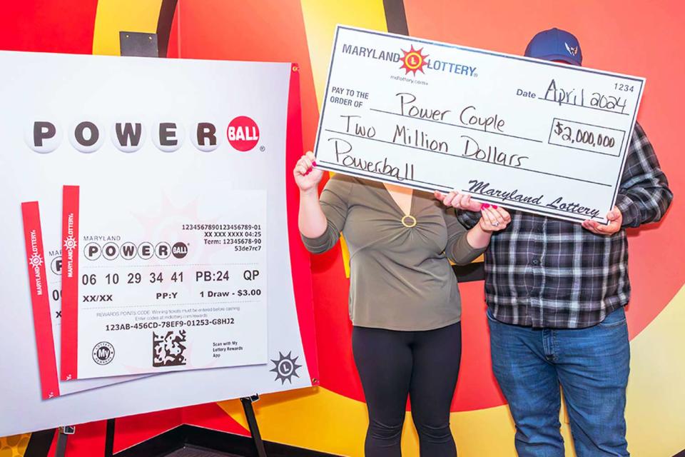 <p>Maryland Lottery</p> Maryland couple poses for photo after husband wins on two tickets