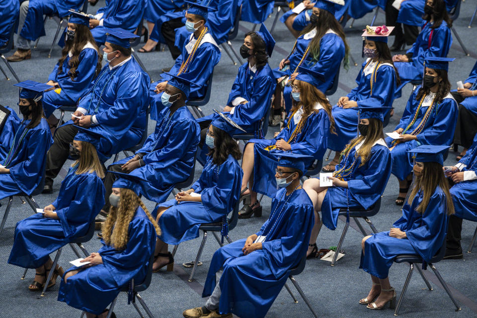 The 2021 graduating class of Odessa Career & Technical Early College High School listens as the salutatorian speaks during their graduation ceremony at Odessa College Sports Center on Friday, May 21, 2021 in Odessa, Texas. (Eli Hartman/Odessa American via AP)