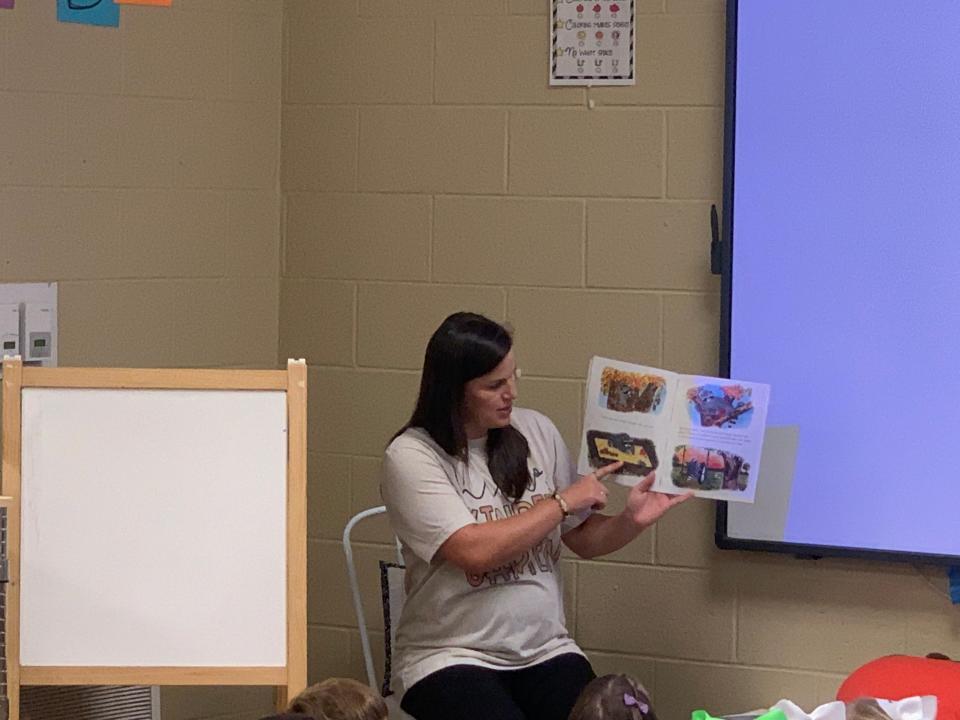 Alexa Clayton, a kindergarten teacher at Glencoe Elementary School, reads a book to her new students as part of United Way's Kinder Camp activities.