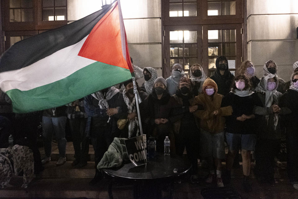 Pro Palestinian students lock arms, sing and chant as they braced for New York Police Department officers to raid campus after Columbia University President Minouche Shafik called on the NYPD to dismantle encampments and remove individuals from Hamilton Hall, Tuesday, April 30, 2024 in New York. (Seyma Bayram via AP)