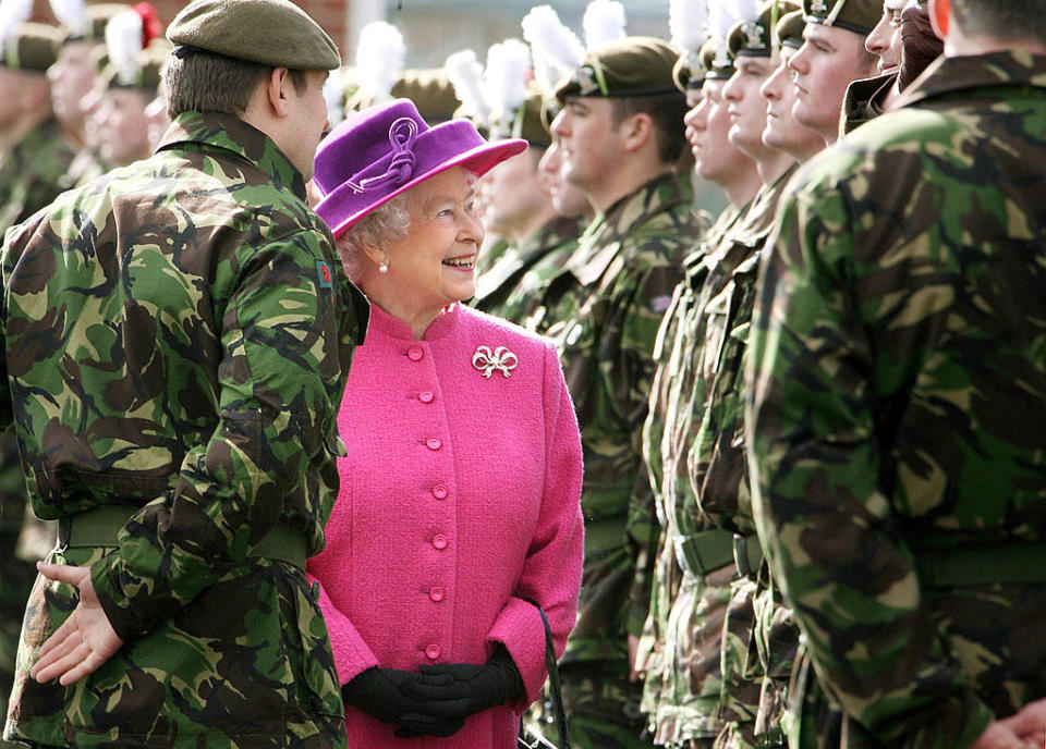 queen smiling with soldiers