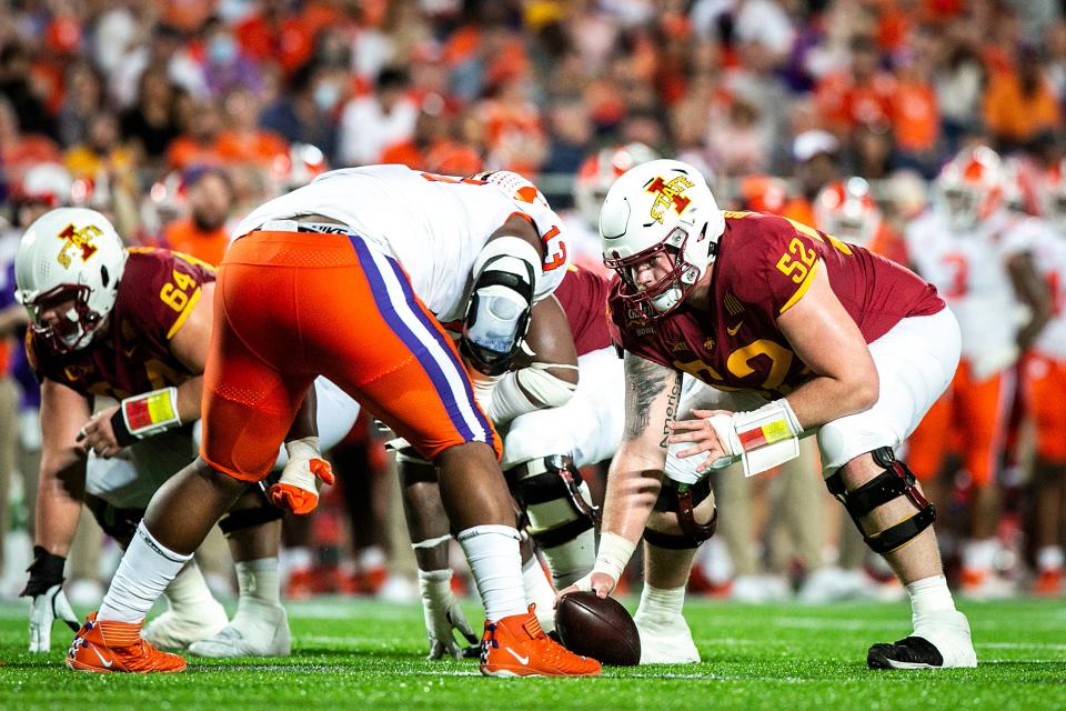Iowa State center Trevor Downing (52) gets set during a NCAA college football game in the Cheez-It Bowl against Clemson, Wednesday, Dec. 29, 2021, at Camping World Stadium in Orlando, Fla.