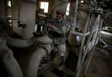 Dadullah, an employee at the Jabal Saraj cement factory, works at a plant in Jabal Saraj, north of Kabul, Afghanistan April 19, 2016. REUTERS/Ahmad Masood