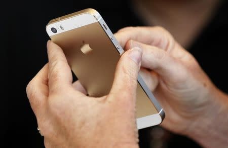 The gold colored version of the new iPhone 5S is seen after Apple Inc's media event in Cupertino, California September 10, 2013. REUTERS/Stephen Lam