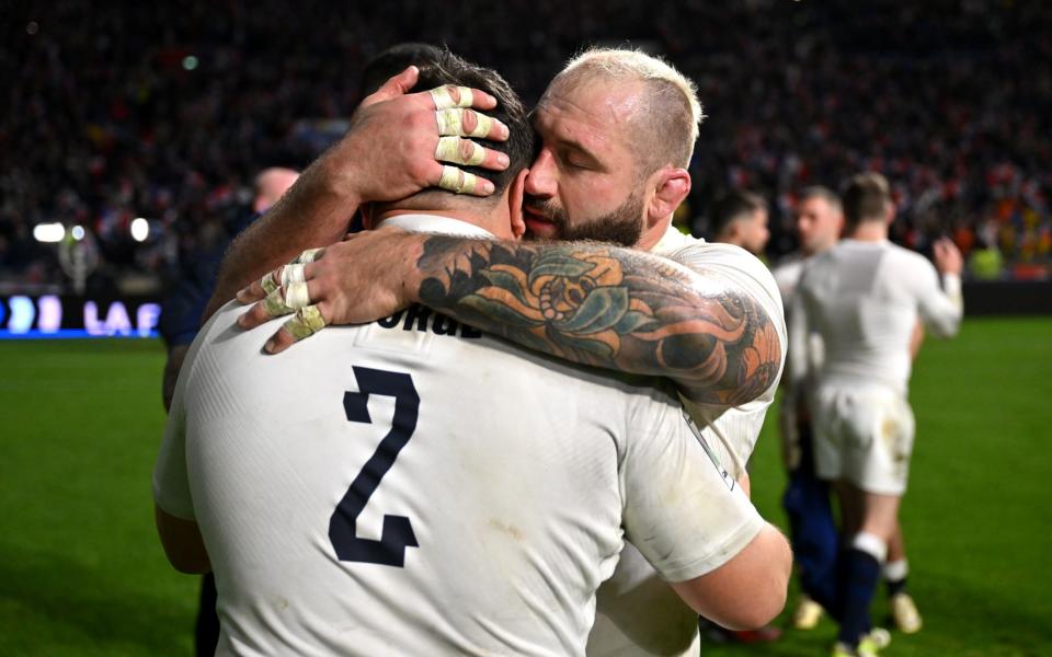 Joe Marler of England embraces teammate Jamie George