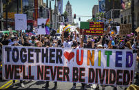 FILE - This photo from Sunday June 14, 2020, shows protesters holding up a banner calling for unity, during an All Black Lives Matter march, organized by black LGBTQ+ leaders in Los Angeles. The chaos unleashed in 2020, amid the coronavirus pandemic, has created space for different voices to speak, for different conversations to be had and for different questions to be asked. (AP Photo/Paula Munoz, File)