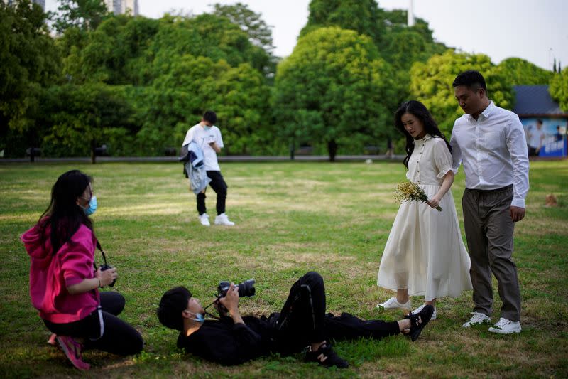 Peng Jing, 24, and Yao Bin, 28, pose for their wedding photography shoot after the lockdown was lifted in Wuhan