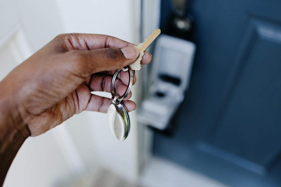 a guy holding a home key