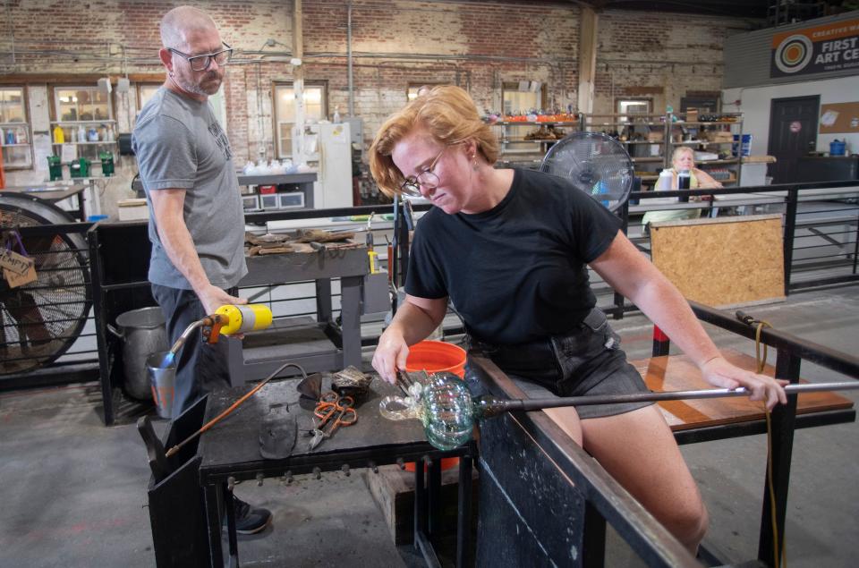 Artists Kellie Sylvester and Keith Jones create the last crop of glass pumpkins at the First City Art Center on Wednesday, Oct. 5, 2022. The glass works of art will be on sale at the organization's 16th annual Glass and Ceramic Pumpkin Patch on Saturday, Oct. 8, from 1 to 4 p.m. at the Blue Wahoos.