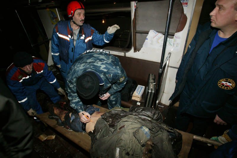 Russian emergency workers carry the body of a victim at Park Kultury metro station in Moscow on March 29, 2010. File Photo by Alex Natin/UPI