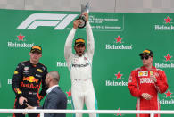 Formula One F1 - Brazilian Grand Prix - Autodromo Jose Carlos Pace, Interlagos, Sao Paulo, Brazil - November 11, 2018 Mercedes' Lewis Hamilton celebrates winning the race with the trophy on the podium with second placed Red Bull's Max Verstappen and third placed Ferrari's Kimi Raikkonen REUTERS/Paulo Whitaker