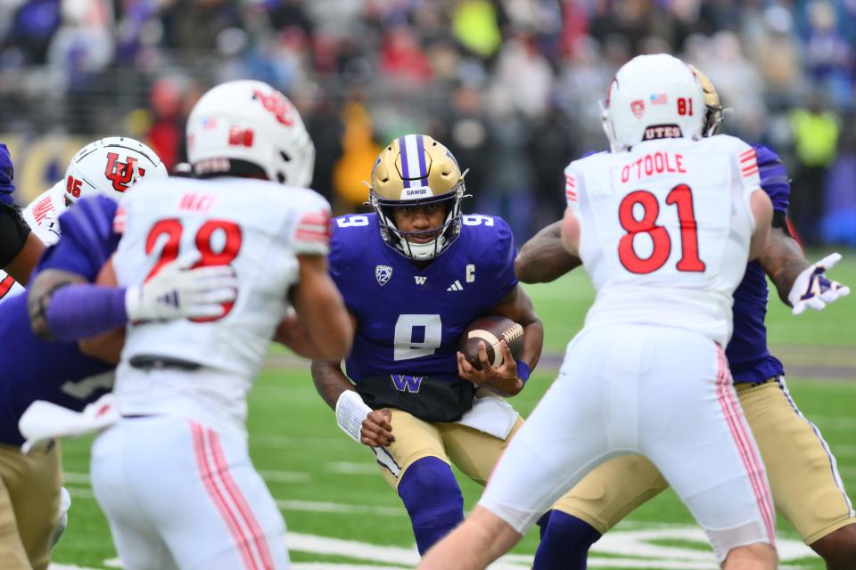 Washington quarterback Michael Penix Jr. (9) carries the ball against Utah during their game at Alaska Airlines Field at Husky Stadium.