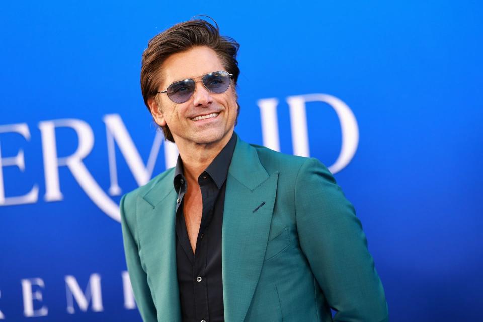 john stamos attends the world premiere of disneys the little mermaid