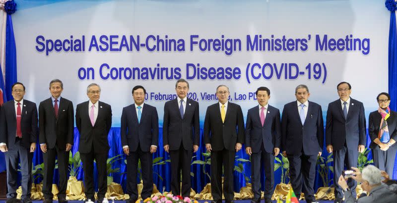 ASEAN foreign ministers pose during an emergency meeting with China's Foreign Minister Wang on the coronavirus outbreak in Vientiane