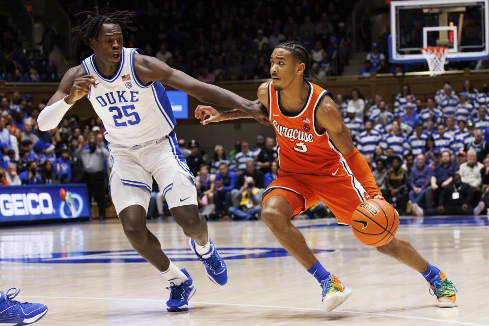 Syracuse's Judah Mintz (3) drives as Duke's Mark Mitchell (25) defends during the first half of an NCAA college basketball game in Durham, N.C., Tuesday, Jan. 2, 2024. (AP Photo/Ben McKeown)