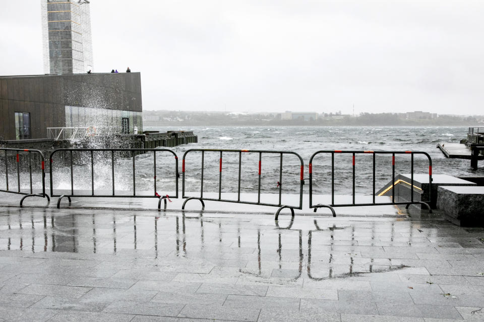 A barricade keeps people away from the crashing waves at the Queen's Marque in Halifax, Nova Scotia, on Saturday, Sept. 16, 2023. Severe conditions were predicted across parts of Massachusetts and Maine, and hurricane conditions could hit the Canadian provinces of New Brunswick and Nova Scotia, where the storm, Lee, downgraded early Saturday from hurricane to post-tropical cyclone, was expected to make landfall later in the day. (Kelly Clark /The Canadian Press via AP)