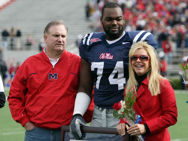 <p>Matthew Sharpe/Getty</p> From left: Sean Tuohy, Michael Oher, and Leigh Anne Tuohy
