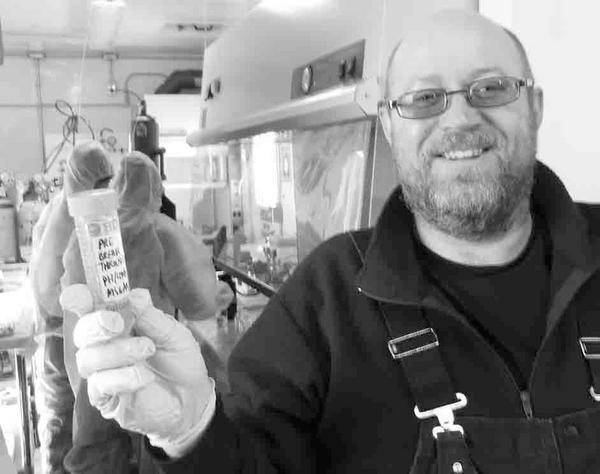 Dr. Mark Skidmore with the first water sample recovered from the borehole. This is not lake water, but a sample recovered from the borehole prior to entry into the lake.