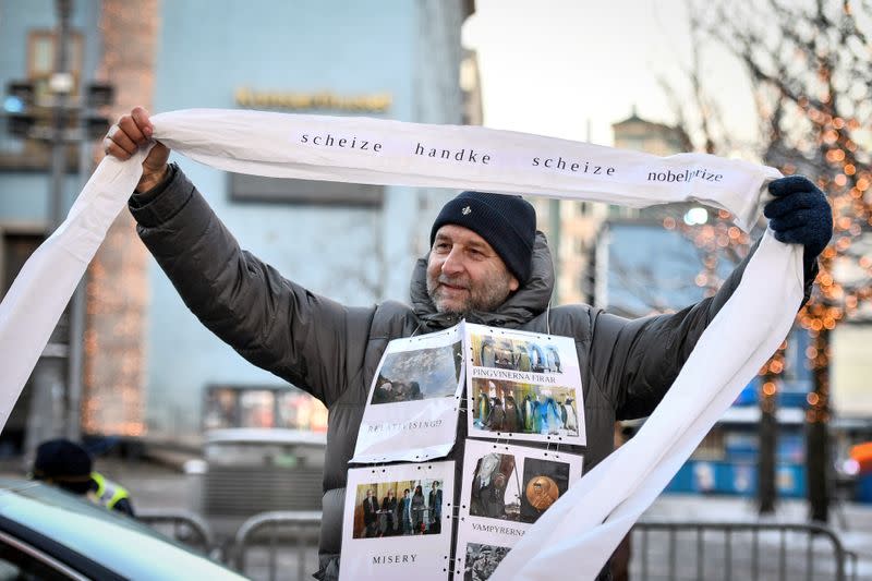 A demonstrator protests against 2019 Nobel literature prize laureate Peter Handke in front of the Stockholm Concert Hall, in Stockholm