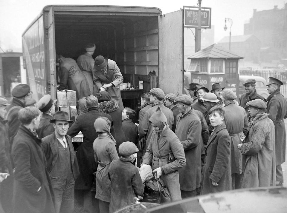 Birmingham Blitz 1940 People buying rationed goods from the back of van parked in the Midland Red bus station at Pool Meadow, Coventry. 18th November 1940 (Photo by Coventry Telegraph Archive/Mirrorpix/Mirrorpix via Getty Images)