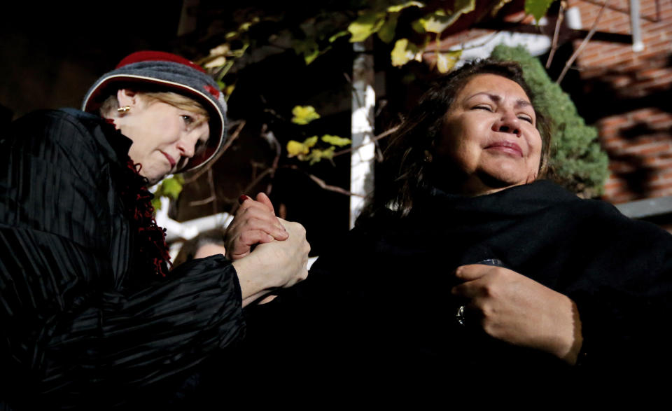 Margaret O'Connor, left, consoles Chef Priscila Satkoff during a candlelight memorial for Chicago chef Charlie Trotter outside Trotter's former restaurant Tuesday, Nov. 5, 2013, in Chicago. Trotter, 54, died Tuesday, a year after closing his namesake Chicago restaurant that was credited with putting his city at the vanguard of the food world and training dozens of the nation's top chefs, including Grant Achatz and Graham Elliot. (AP Photo/Charles Rex Arbogast)