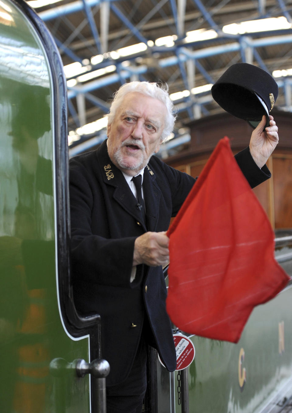 FILE - Bernard Cribbins arrives at Waterloo Station, in London onboard the 66 tonne Stirling Single, the train used in the original Railway Children film, June 3, 2010. Cribbins, a beloved British entertainer whose seven-decade career ranged from the bawdy “Carry On” comedies to children’s television and “Doctor Who,” has died. He was 93. Agent Gavin Barker Associates announced Cribbins’ death on Thursday, July 28, 2022. (Anthony Devlin/PA via AP, File)