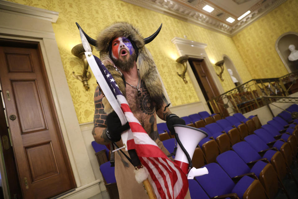 Shirtless Trump supporter Jacob Chansley, also known as Jake Angeli, pictured is a fur hat with horns during the US riots.