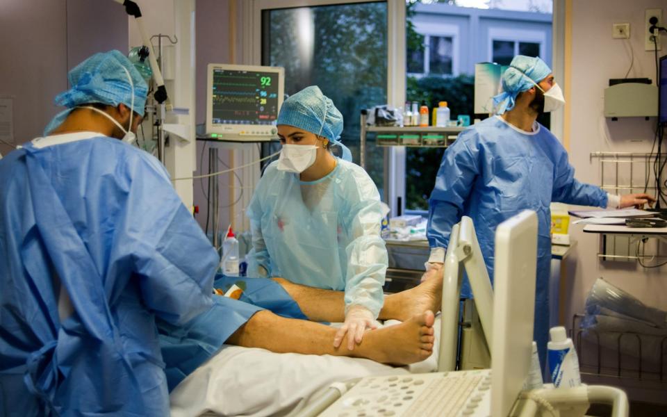 Nurses and doctors treat a Covid-19 patient in the intensive care unit (ICU) at the Ambroise Pare Clinic in Paris, France -  Nathan Laine/Bloomberg