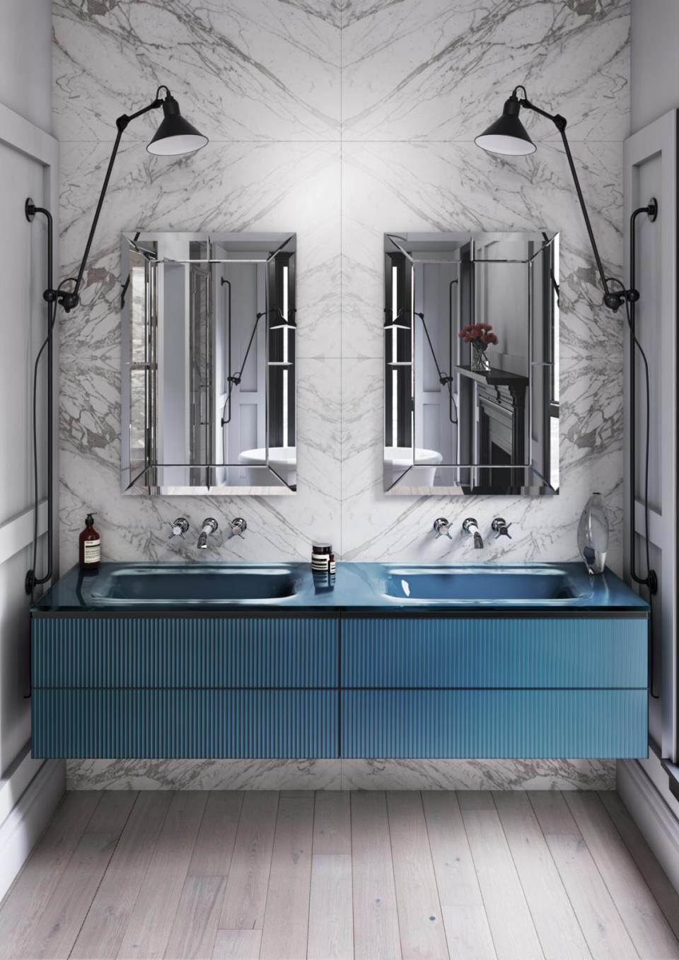 modern bathroom with marble wall tiles and blue cabinetry