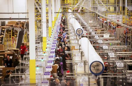 Workers prepare outgoing shipments at an Amazon Fulfillment Center, ahead of the Christmas rush, in Tracy, California, in this file photo from November 30, 2014. REUTERS/Noah Berger/Files