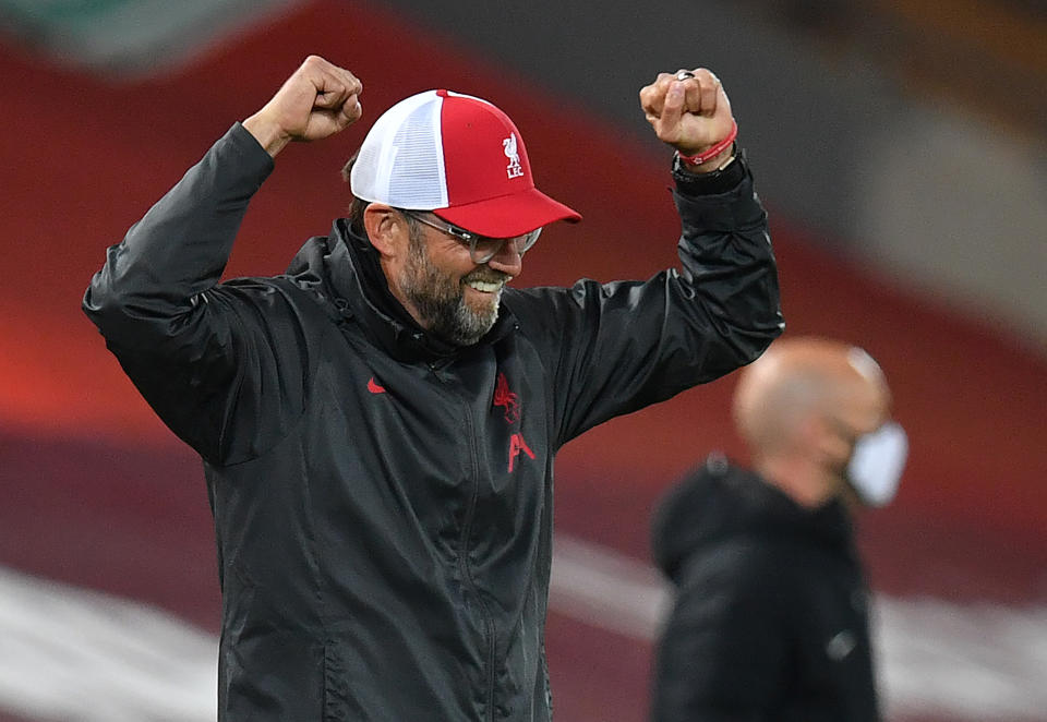 Jurgen Klopp celebrating with his arms raised.