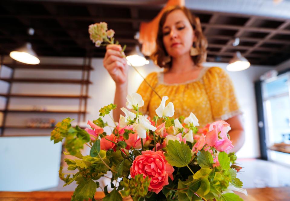 Cherrelle Hitchcock builds a floral arrangement at  Serendipity, a new store located at 215 W. Commercial St.