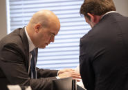 Prosecutor John Conrad, left, talks with defense attorney Phillip Barber in the double murder trial of Alex Murdaugh at the Colleton County Courthouse in Walterboro, S.C., Wednesday, Feb. 1, 2023. (Andrew J. Whitaker/The Post And Courier via AP, Pool)