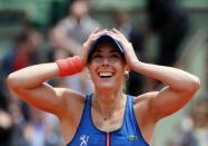 Alize Cornet of France celebrates after beating Mirjana Lucic-Baroni of Croatia during their women's singles match at the French Open tennis tournament at the Roland Garros stadium in Paris, France, May 29, 2015. REUTERS/Jean-Paul Pelissier