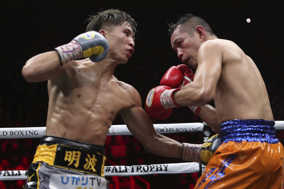 Japan's Naoya Inoue, left, sends a left to Philippines' Nonito Donaire in the 10th round of their World Boxing Super Series bantamweight final match in Saitama, Japan, Thursday, Nov. 7, 2019. Inoue beat Donaire with a unanimous decision to win the championship. (AP Photo/Toru Takahashi)