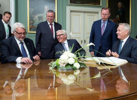 Poland's Foreign Minister Witold Waszczykowski (L to R), German Foreign Minister Frank-Walter Steinmeier and French Foreign Minister Jean-Marc Ayraultin sign the "Golden Book' of the city of Weimar besides Bodo Ramelow, governor of the German state of Thuringia, (2nd R), and Stefan Wolf, Lord Mayor of Weimar, (3rd L), during the Weimar Triangle meeting in Weimar, Germany, August 28, 2016. REUTERS/Jens Meyer/Pool