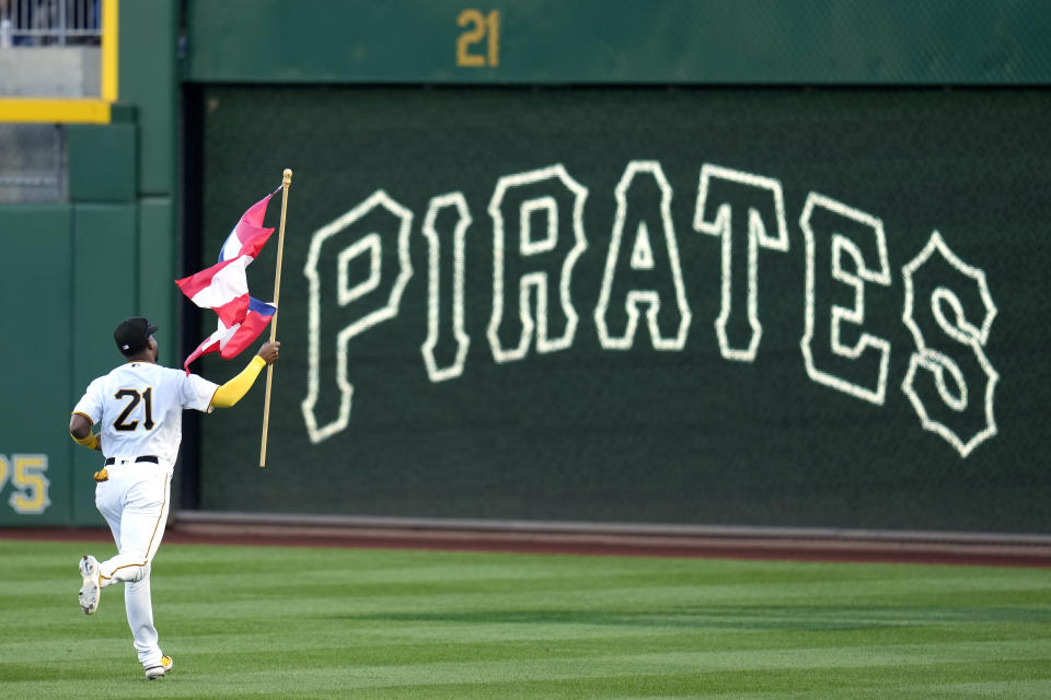 Pittsburgh Pirates right fielder Joshua Palacios carries a Puerto Rican flag for Roberto Clemente Day to his position in right field, before the team's baseball game against the New York Yankees in Pittsburgh, Friday, Sept. 15, 2023. (AP Photo/Gene J. Puskar)