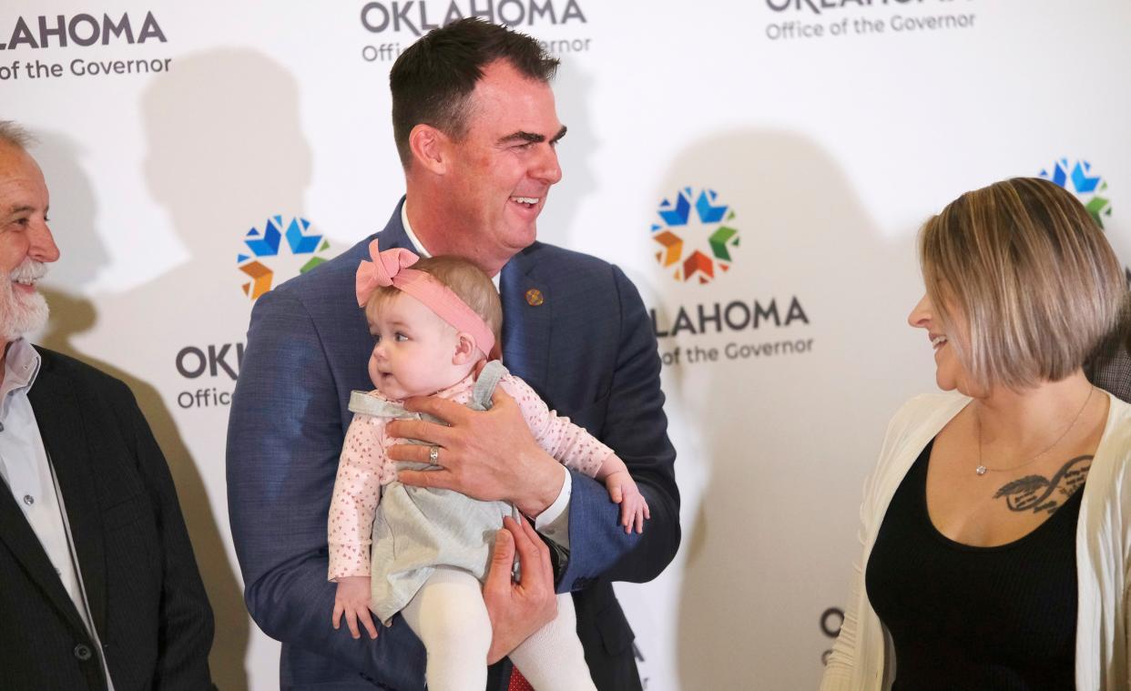 Gov. Kevin Stitt holds seven month old Camila Pollard as her mother, Ciera Pollard, right, watches after a press conference to announce the expansion of SoonerCare for pregnancy and postpartum care at the Oklahoma Capitol on Monday.