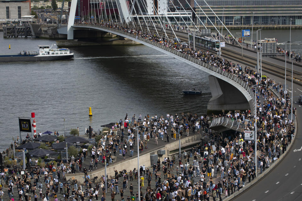 Thousands of people line Erasmus bridge as they take part in a demonstration in Rotterdam, Netherlands, Wednesday, June 3, 2020, to protest against the recent killing of George Floyd, police violence and institutionalized racism. Floyd, a black man, died in police custody in Minneapolis, U.S.A., after being restrained by police officers on May 25, 2020. (AP Photo/Peter Dejong)