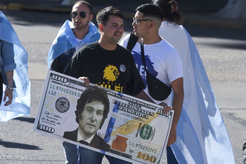 Supporters of Argentina's incoming President Javier Milei gather outside the Congress prior to his swearing-in ceremony in Buenos Aires, 10 December 2023