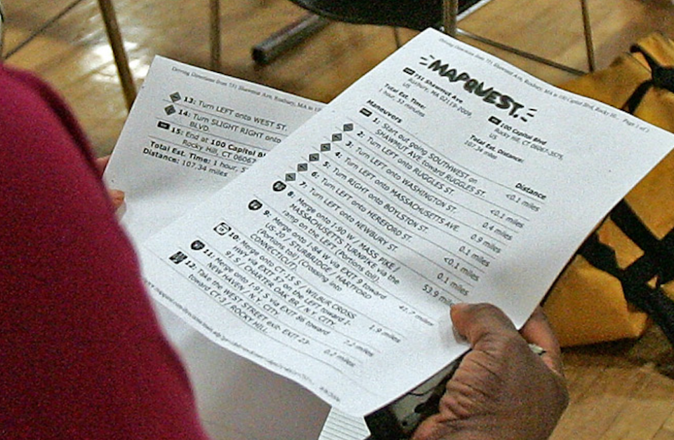 A person reviewing a detailed voting ballot during an election