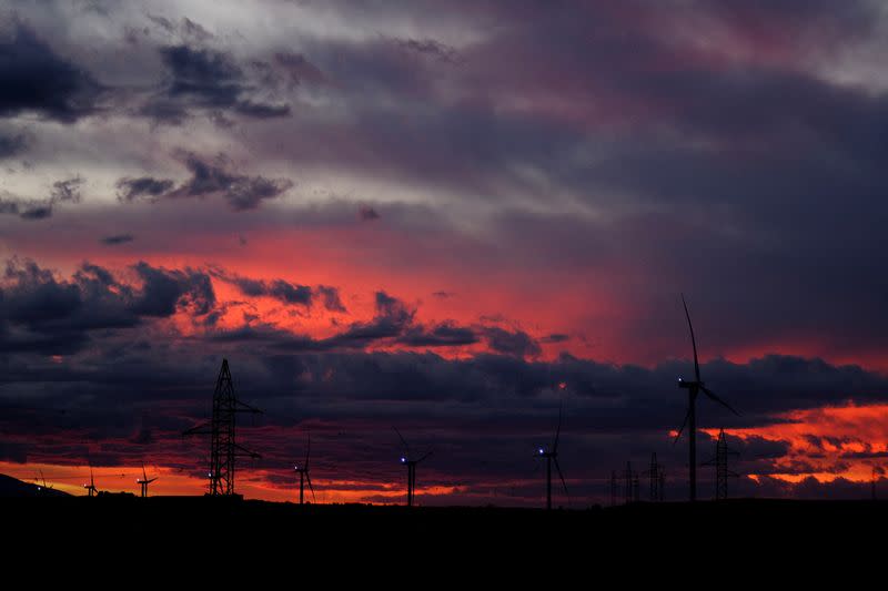 FILE PHOTO: A view shows wind turbines during sunset in Alagon